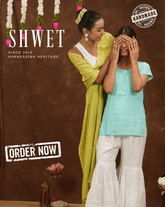 Woman wearing a pink saree with a brown background, featuring the brand 'SHWET'.