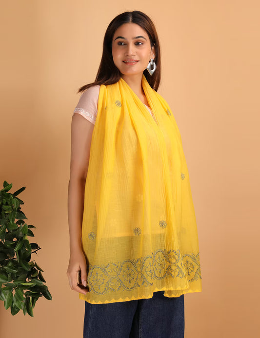 Woman wearing a yellow scarf with Hand Embroidered Chikankari patterns on a beige background