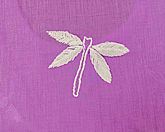 Chikankari Embroidered dragonfly design on a purple fabric background