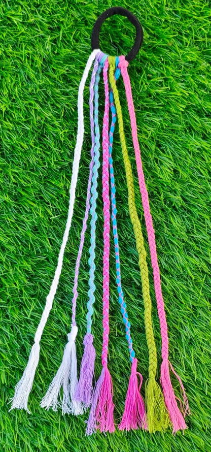 Colorful tassel hair tie on a grass background