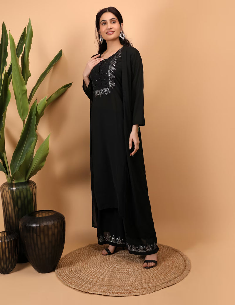 Woman wearing a black Kurti Plazzo Shrug Set with lace details on a beige background