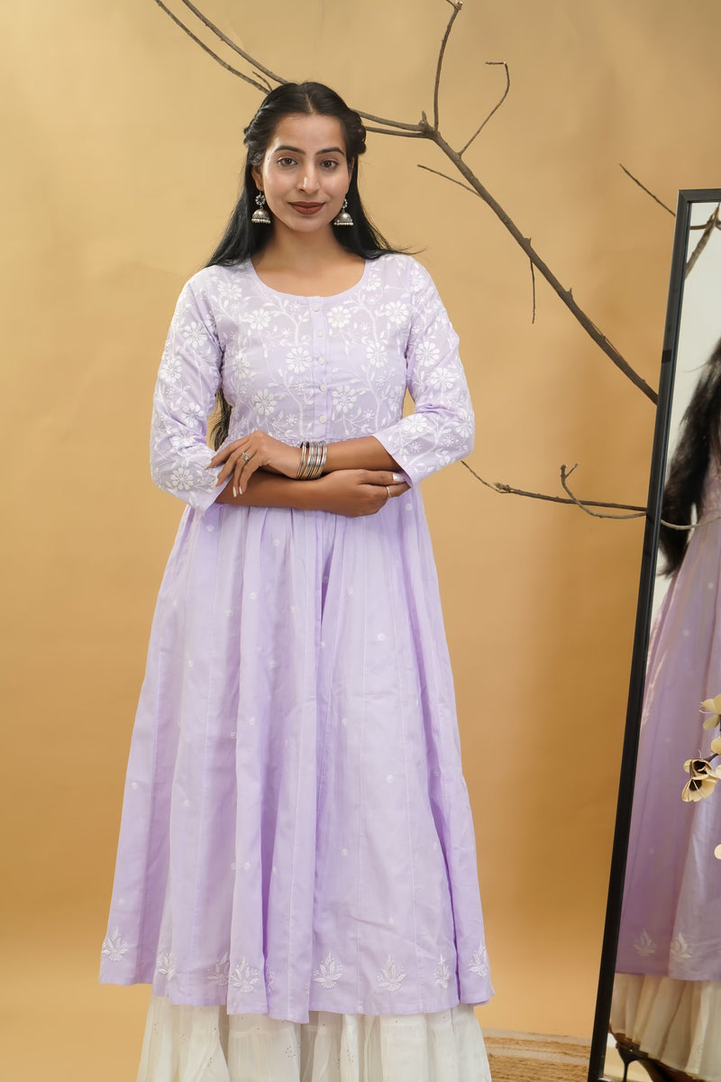 Woman wearing a light purple dress with a beige background