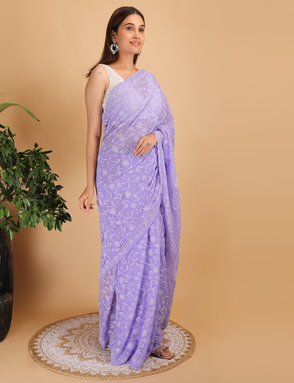 Woman wearing a purple  Chikankari saree with a white background