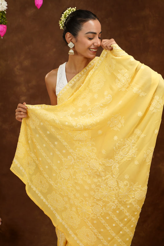 Woman holding a yellow embroidered scarf against a brown background