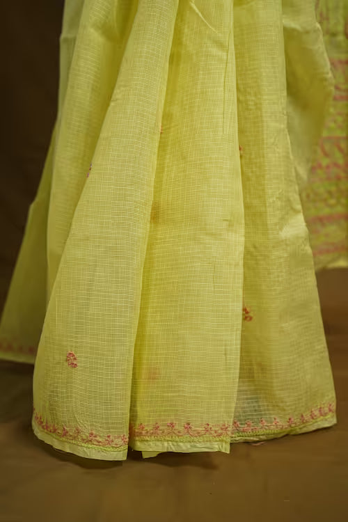 Light yellow  fabric with intricate patterns on a brown background