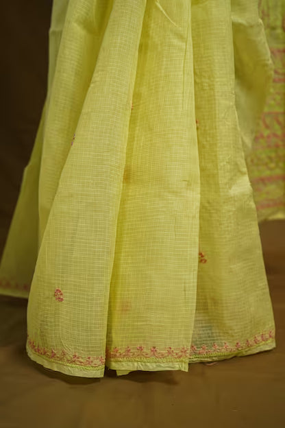 Light yellow  fabric with intricate patterns on a brown background