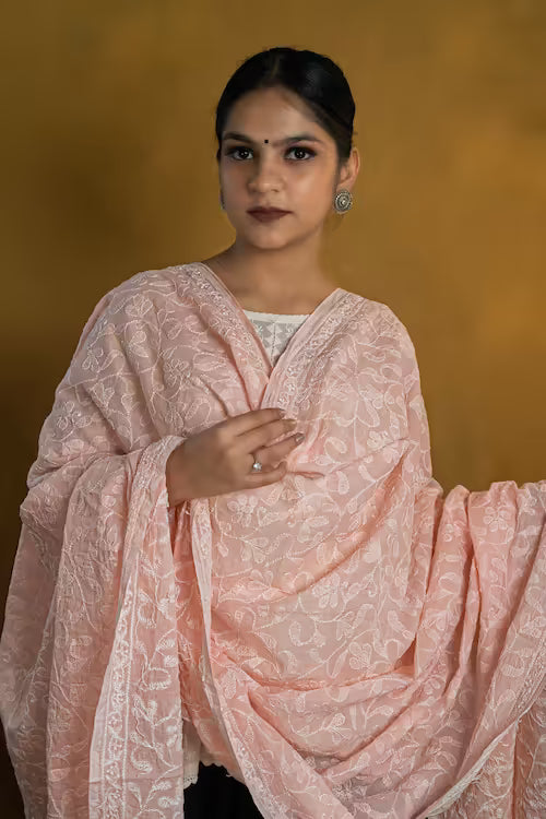 Woman wearing a peach traditional outfit with a blurred background