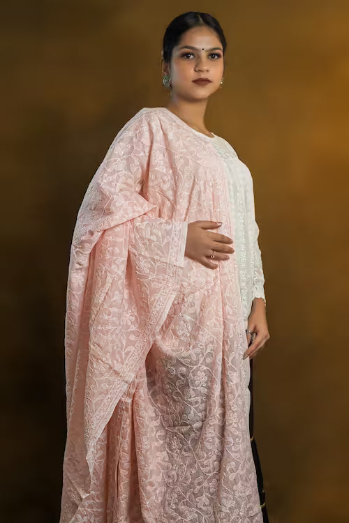 Woman wearing a peach traditional outfit against a warm brown background
