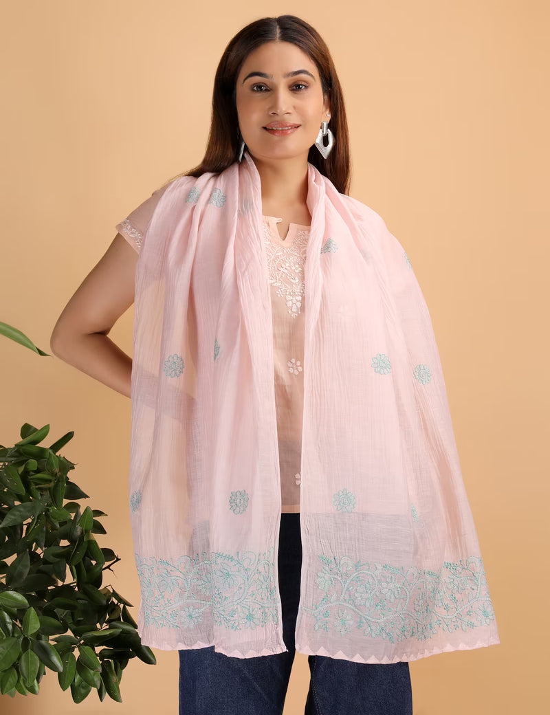 Woman wearing a light pink scarf with  Hand Embroidered Chikankari patterns on a beige background