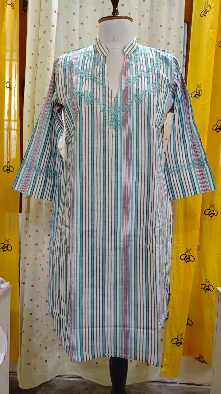 Striped  Chikankari kurta on a mannequin against a yellow curtain with black bee pattern