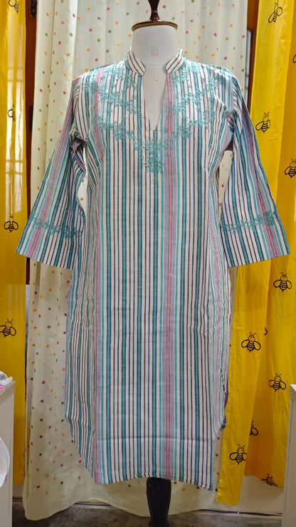 Striped  Chikankari kurta on a mannequin against a yellow curtain with black bee pattern