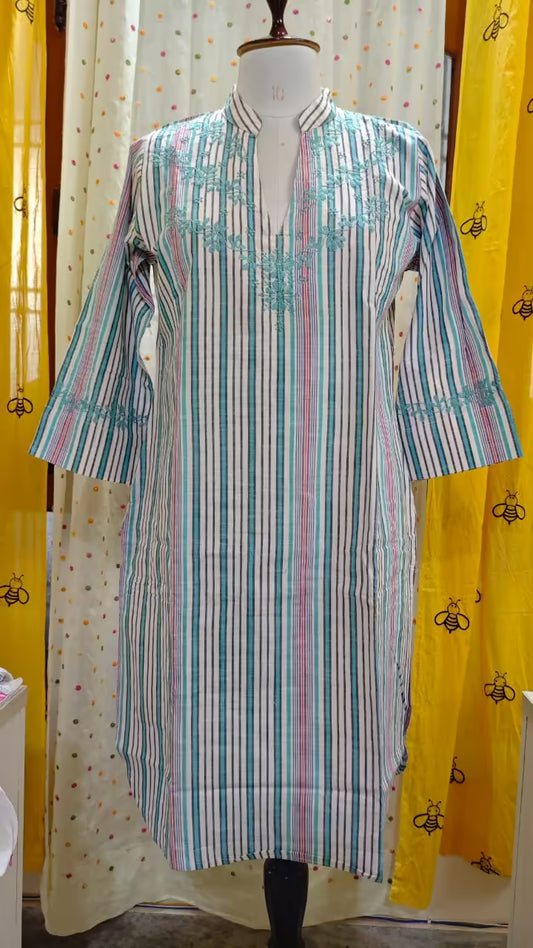Striped  Chikankari kurta on a mannequin against a yellow curtain with black bee pattern