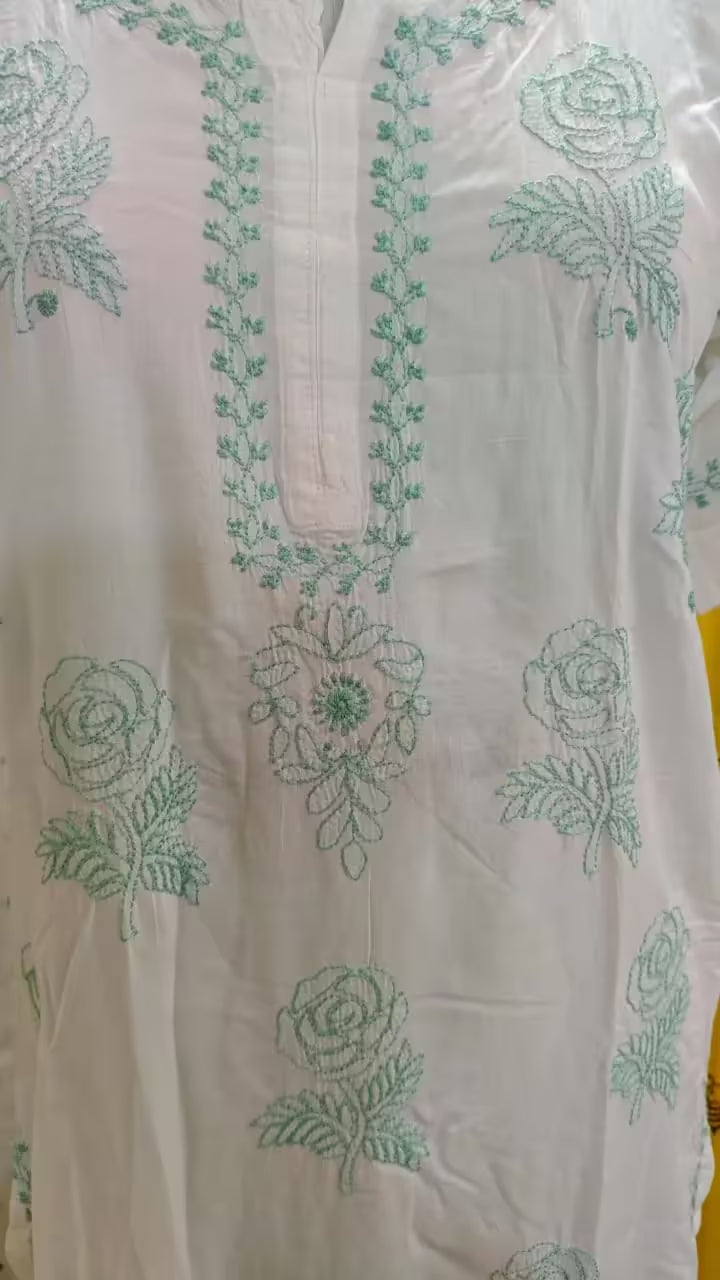White fabric with green Chikankari embroidery on a clear background