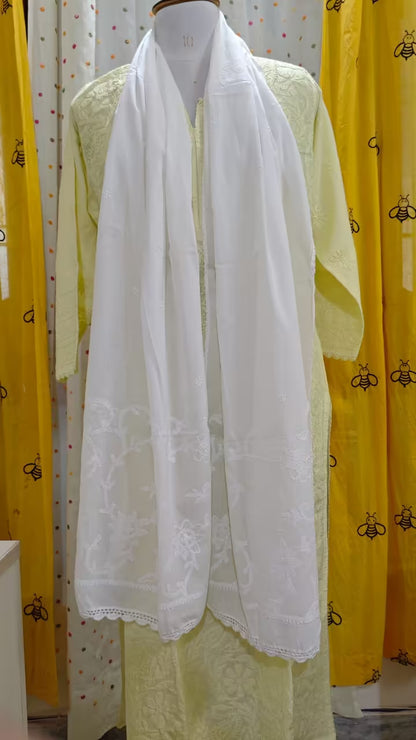 White  chikankari scarf on a mannequin with yellow fabric and bee pattern in the background