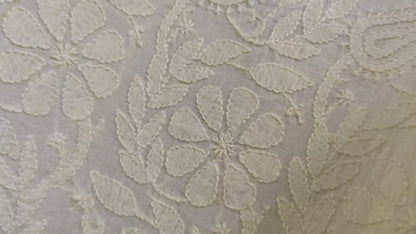 Chikankari  patterned fabric with light   flowers on a gray background