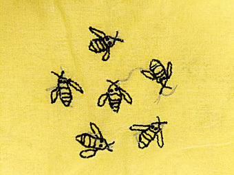 Pechni Chikankari pattern bees on a yellow fabric background