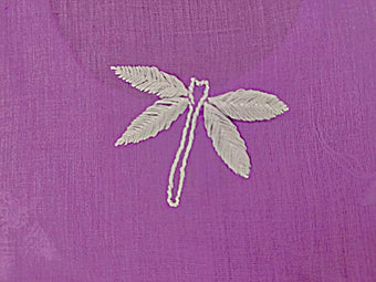 White Ghaspatti chikankari stitch  dragonfly on a purple fabric background
