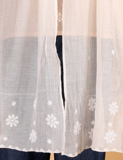 Sheer white Stole with floral embroidery on a beige background