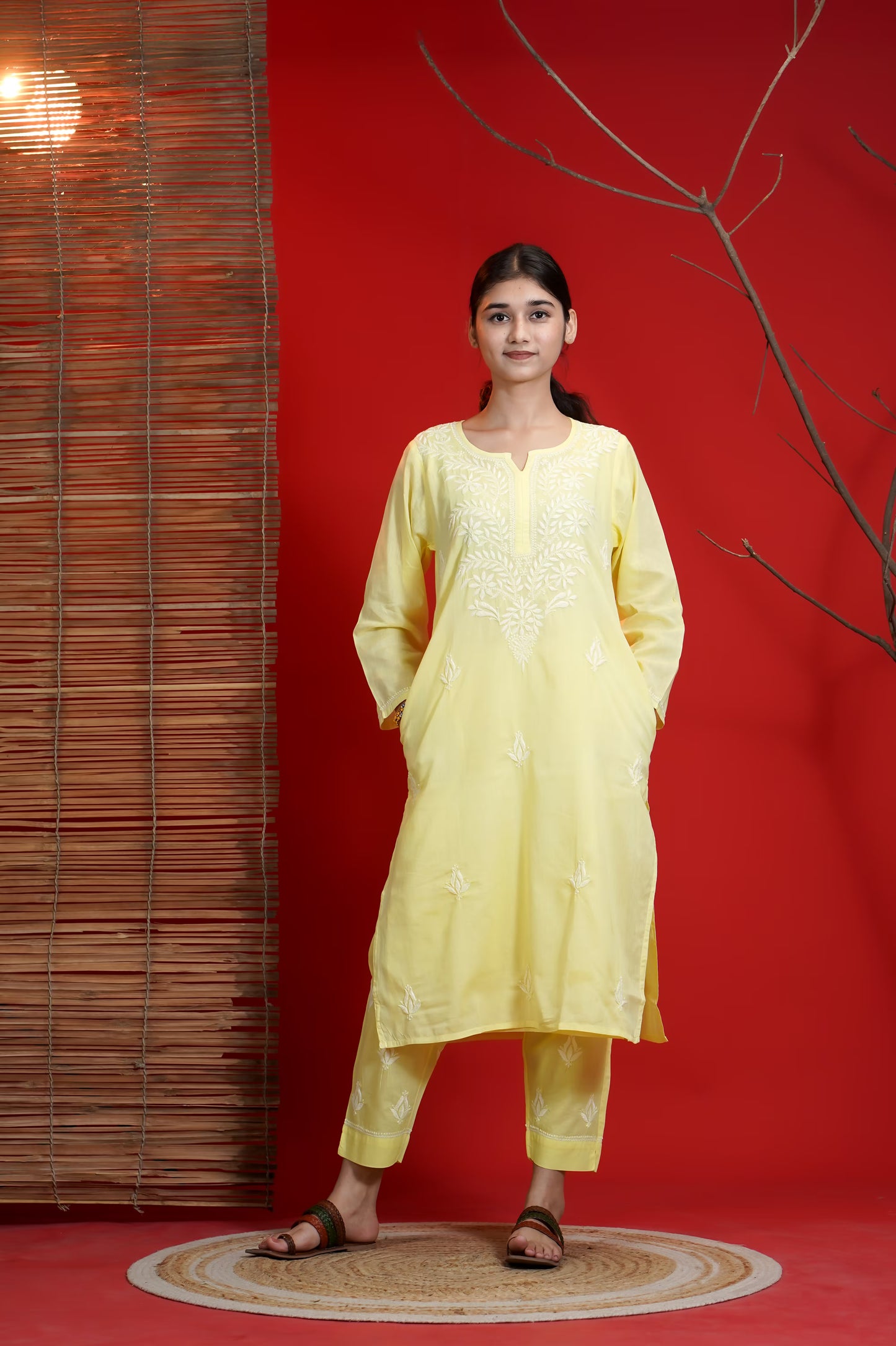 Woman wearing a yellow traditional outfit against a red background