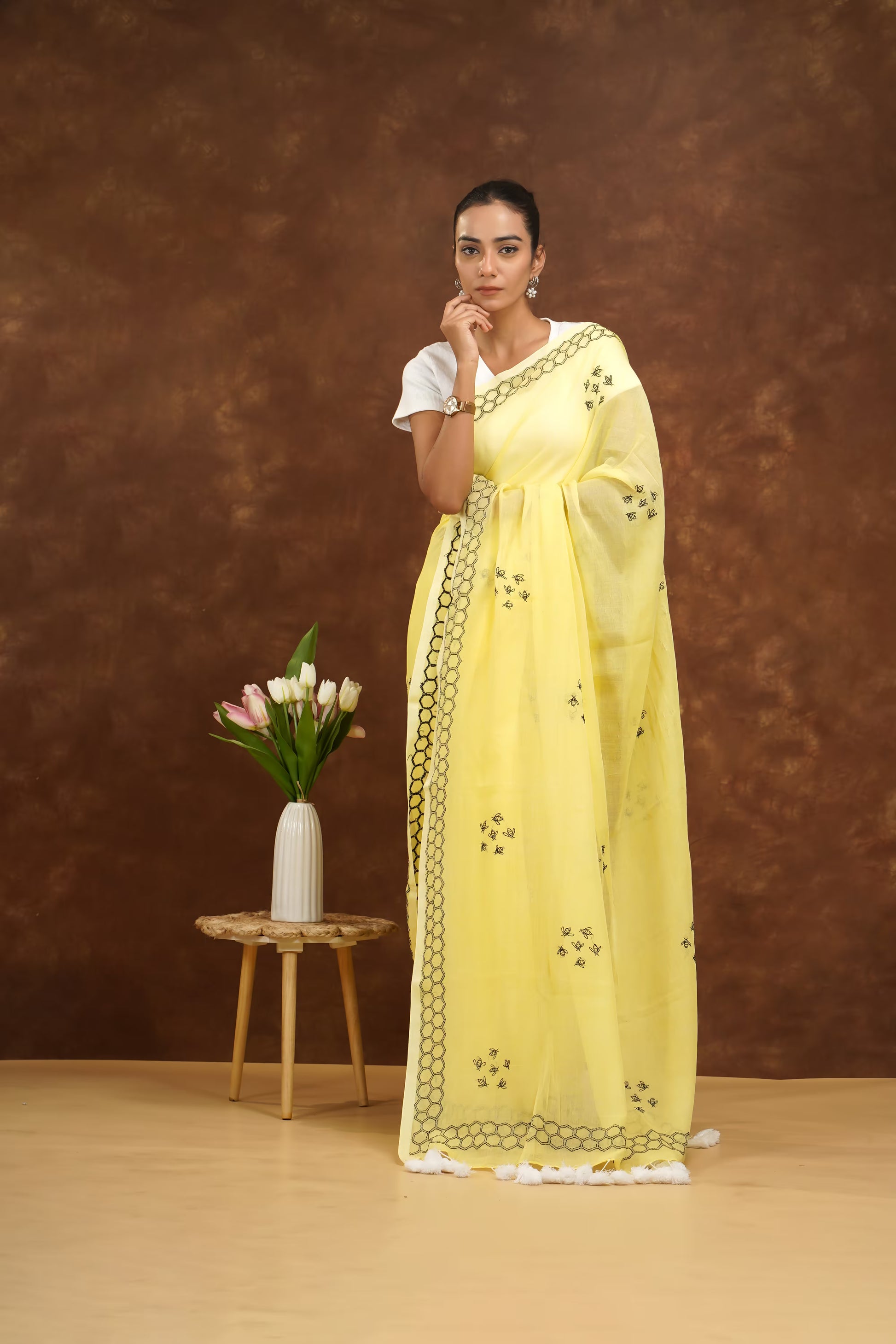 Woman in a yellow saree with a white background