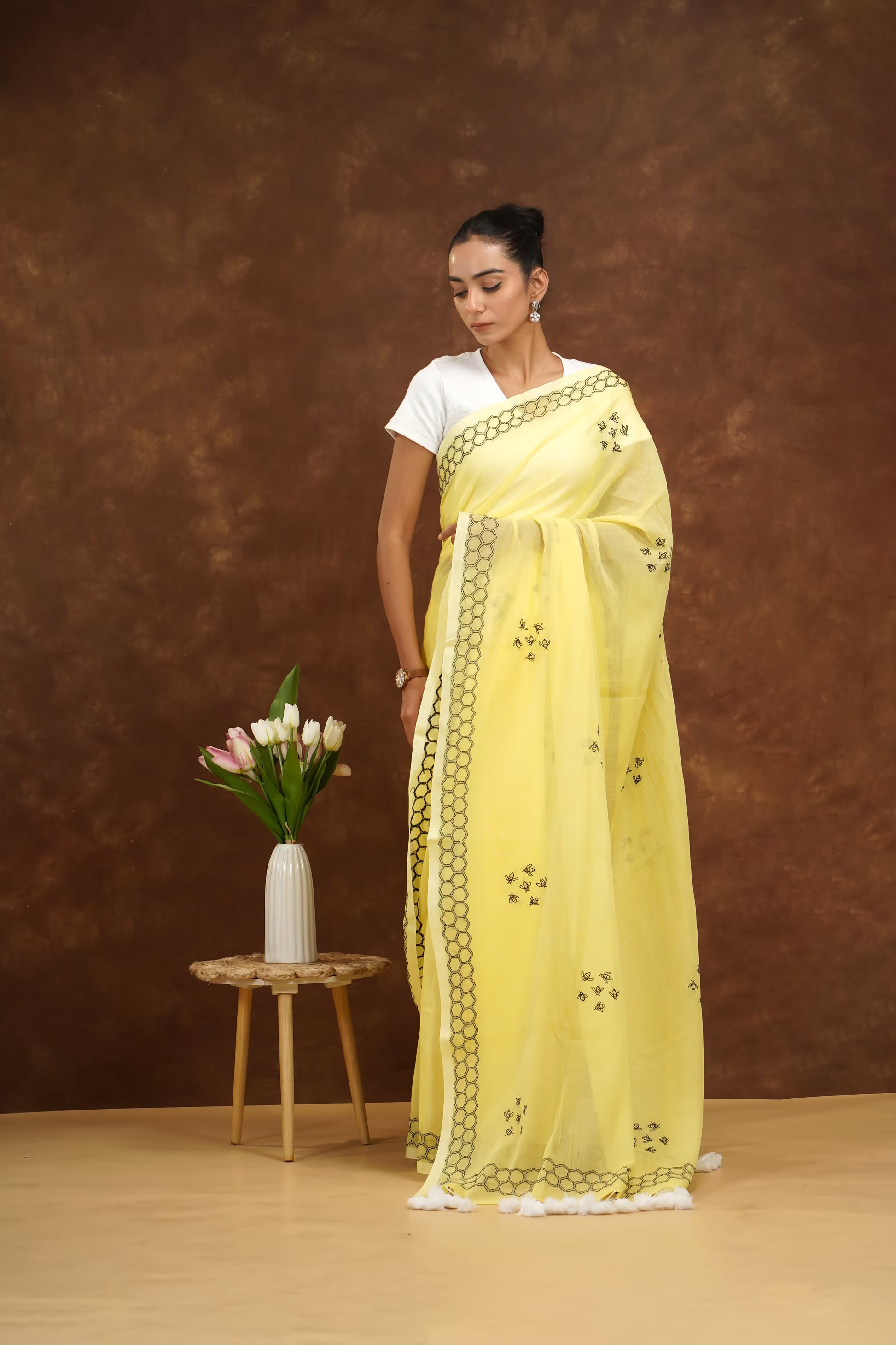 Woman in a yellow saree with a white background